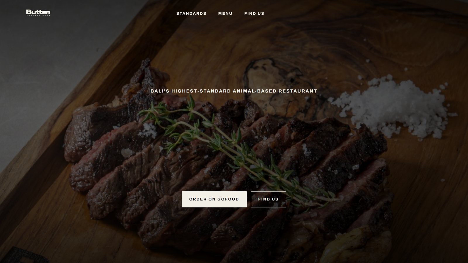 A restaurant website in Bali, black with condensed poster type and full bleed food photography